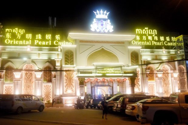 This photo taken on December 13, 2018 shows one of the many Chinese casino establishments in  Sihanoukville, the coastal capital of Preah Sihanouk province. - Cambodia's love affair with its communist neighbour has meant big bucks for the once-impoverished Southeast Asian country, injecting billions into its economy without questions about its abysmal rights record. And China's largesse is none more apparent than in Sihanoukville, the nexus of China's "One Belt, One Road" infrastructure plan which includes a planned highway to Phnom Penh. (Photo by TANG CHHIN Sothy / AFP) / To go with Cambodia-China-development-politics, FEATURE by Sophie DEVILLER and Suy SE