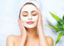 spa woman applying facial cleansing mask