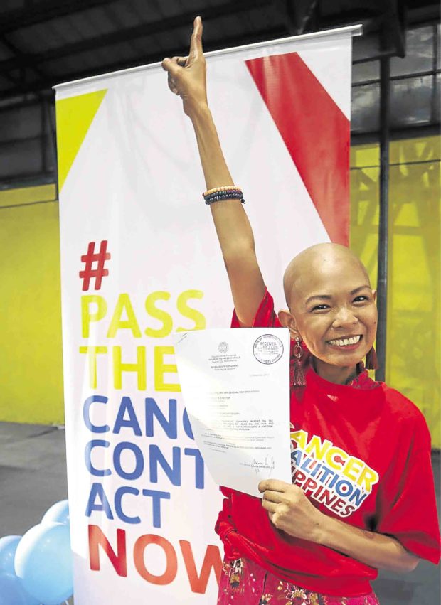 Cancer survivor Lea Ramos-Hirashi celebrates as the Cancer Control Act progresses toward becoming a law. —KARA ALIKPALA