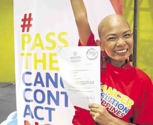 Cancer survivor Lea Ramos-Hirashi celebrates as the Cancer Control Act progresses toward becoming a law. —KARA ALIKPALA