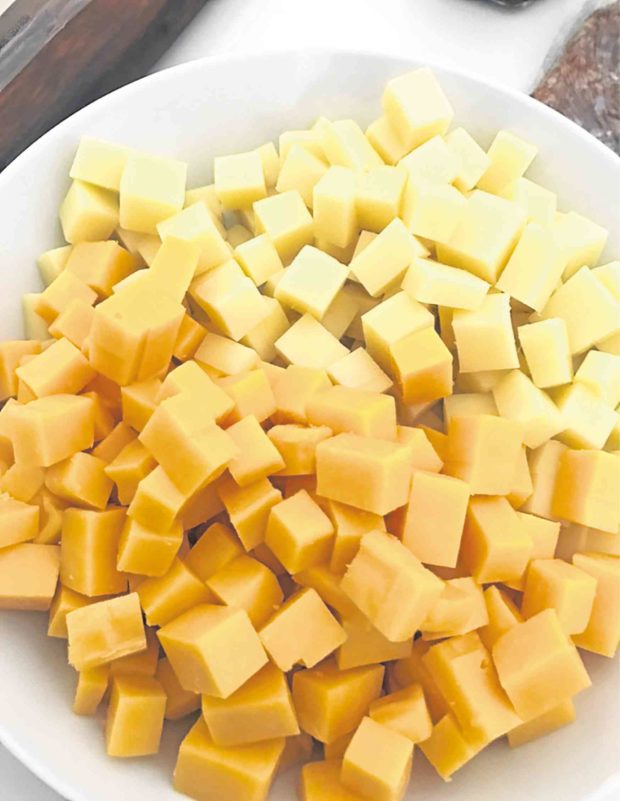 Assorted cheese in bite-size portions and thick wedges
