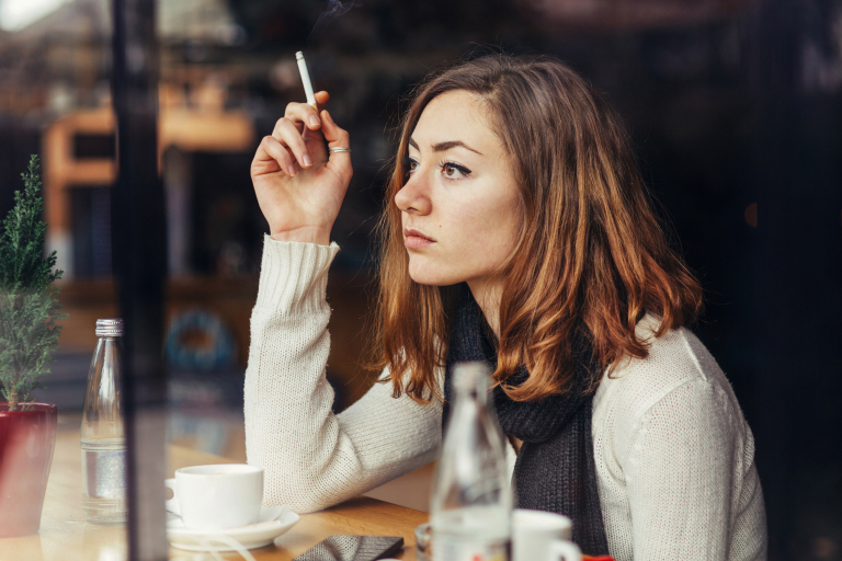 young woman smoking cafe