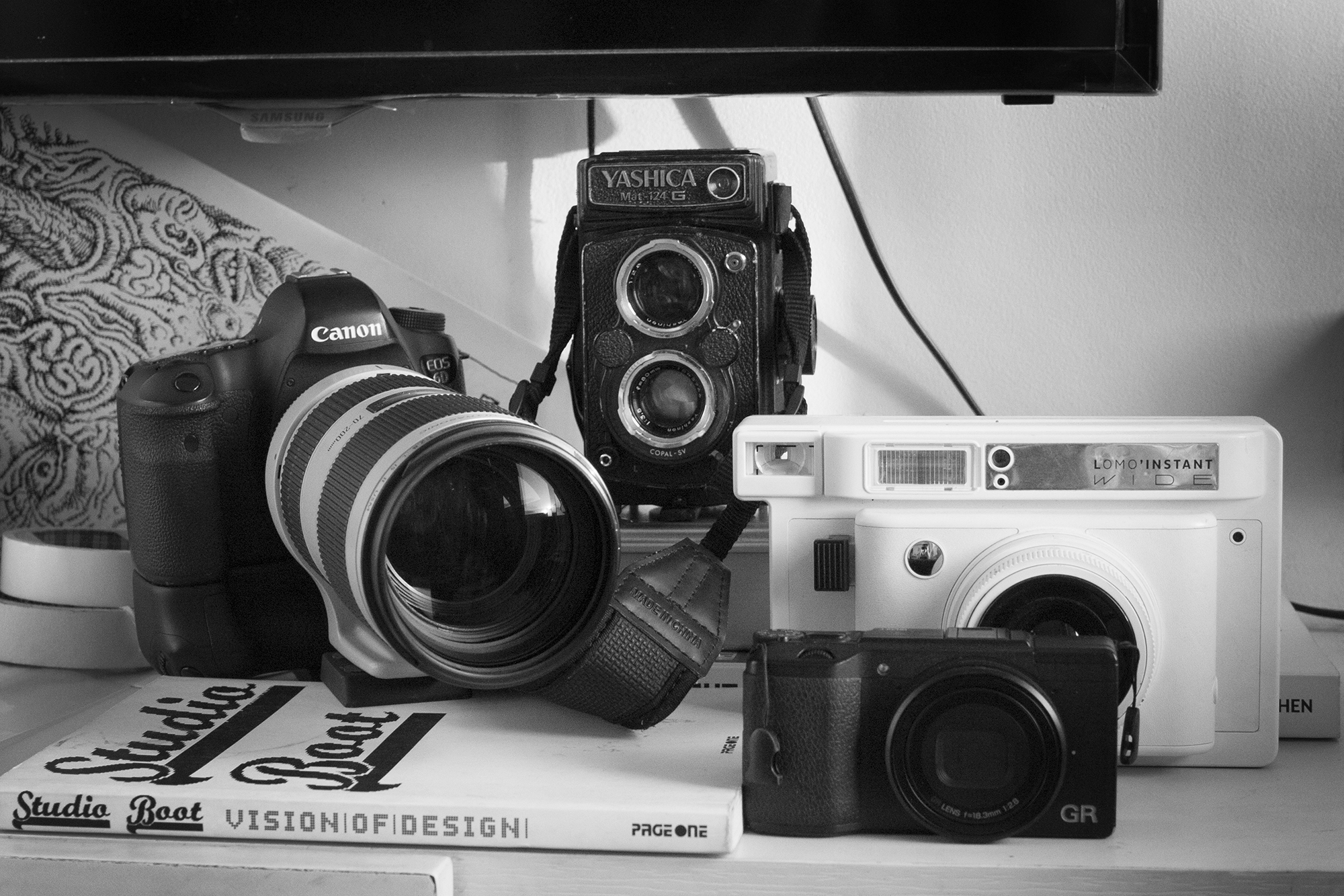 Some of Jack’s cameras: Canon 6D DSLR, Yashica Mat-124G, Lomo’Instant Wide, and Ricoh GR II. PHOTO © JED GREGORIO