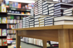 Books stacked on table at bookstore