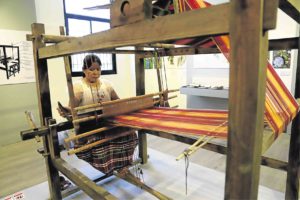 Weaver at Habol Panay textile gallery at the National Museum of Western Visayas