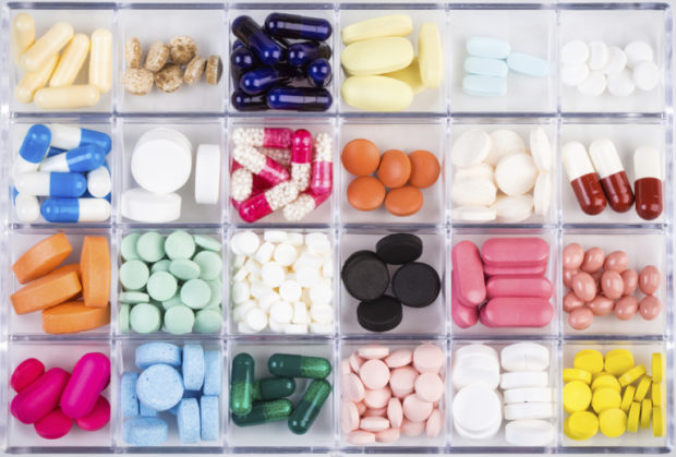 Various pills and capsules in container