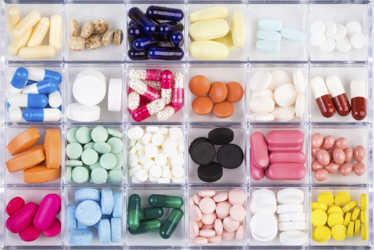 Various pills and capsules in container
