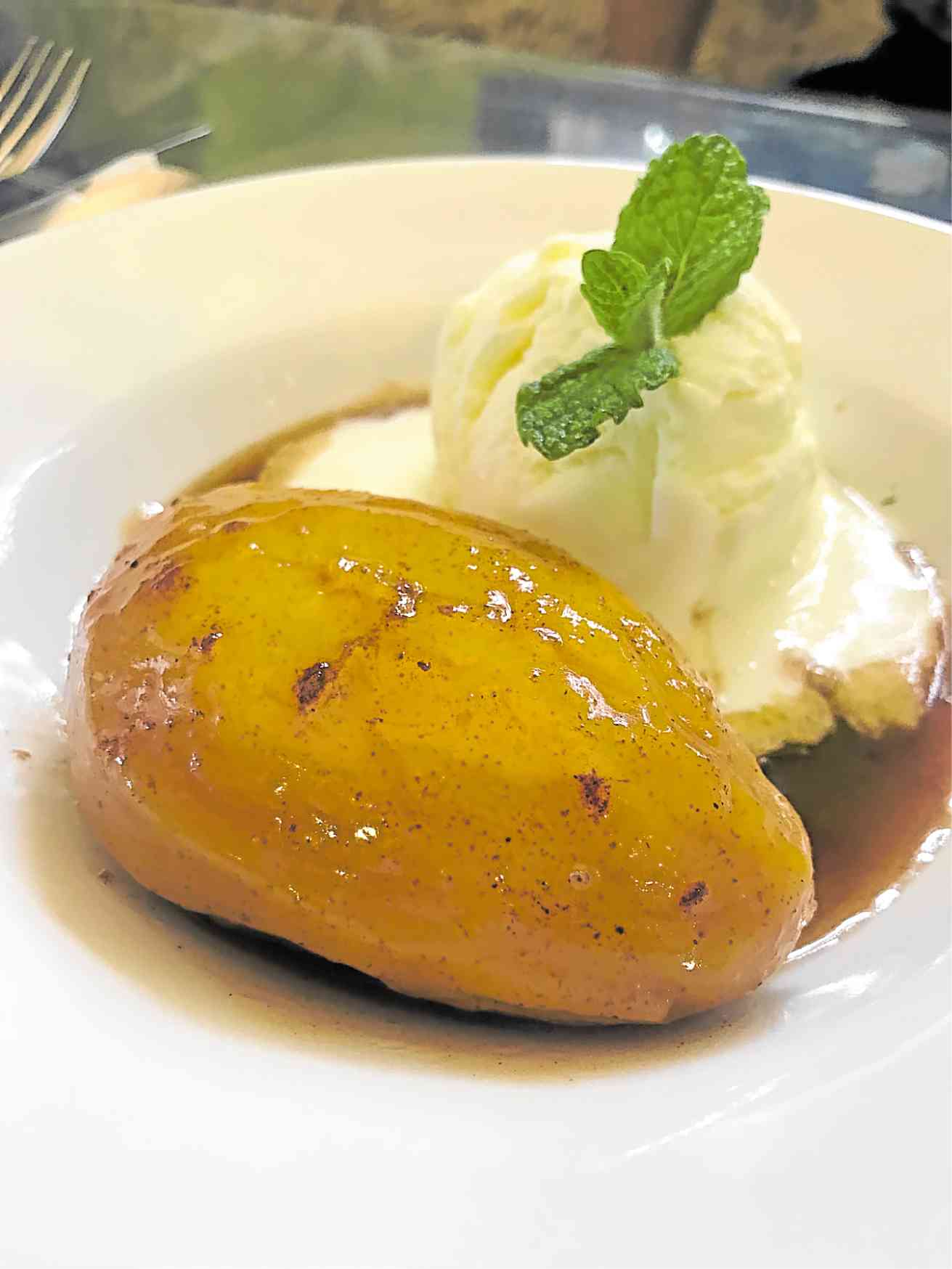 Bamba Bistro’s baked mango with vanilla ice cream