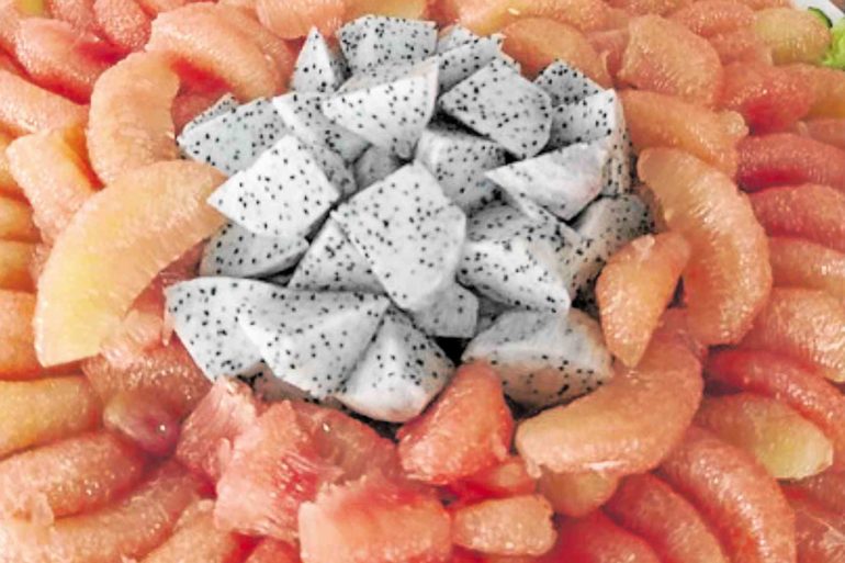 Pomelo sections and sliced dragon fruit