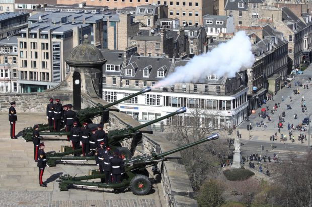Members of the 105th Regiment Royal Artillery fire the Death Gun Salute to mark the passing of Britain's Prince Philip, Duke of Edinburgh, at Edinburgh Castle in Edinburgh, Scotland on April 10, 2021, the day after his death at the age of 99. - Military guns will be fired across Britain and sporting events will fall silent on Saturday as part of worldwide tributes to mark the death of Queen Elizabeth II's husband, Prince Philip