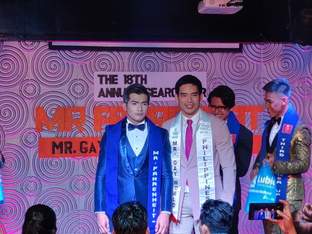 Kodie Macayan receives the Mister Gay World Philippines title from then reigning Mister Gay World Janjep Carlos at the 2020 Mister Fahrenheit search