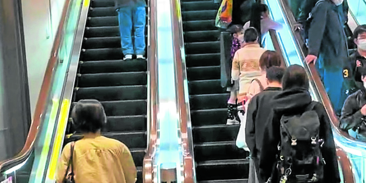 People usually stay on one side of the escalator to let others pass.