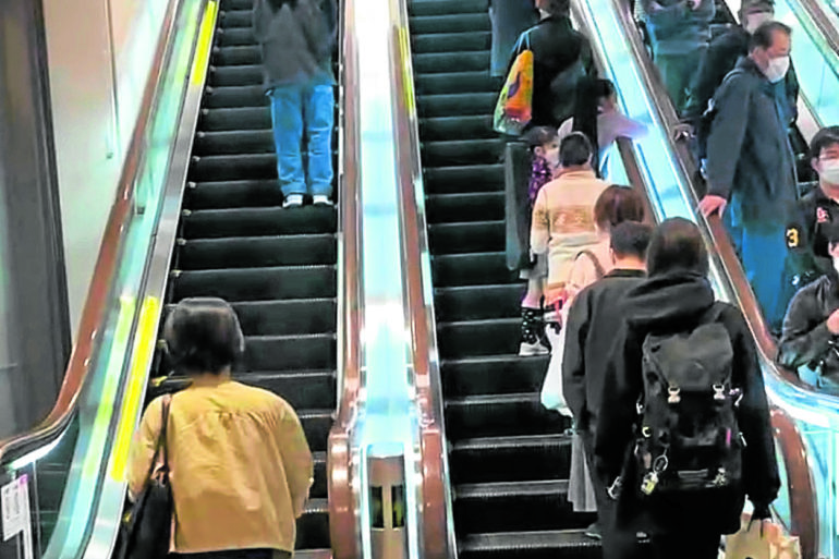 People usually stay on one side of the escalator to let others pass.