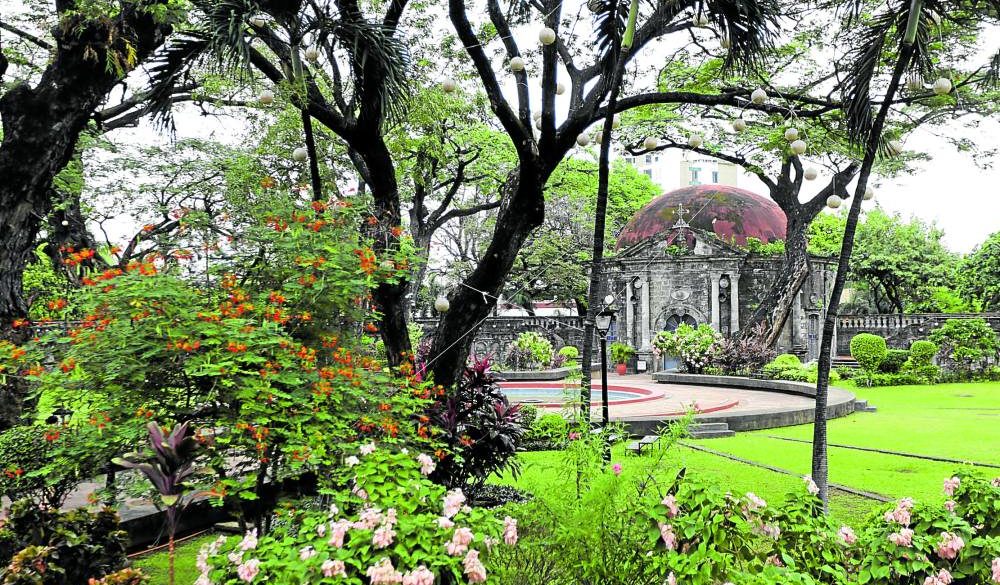Paco Park is cited as a national treasure by the National Museum. St. Pancratius Chapel, managed separately by Adamson University, peers behind the trees and foliage.