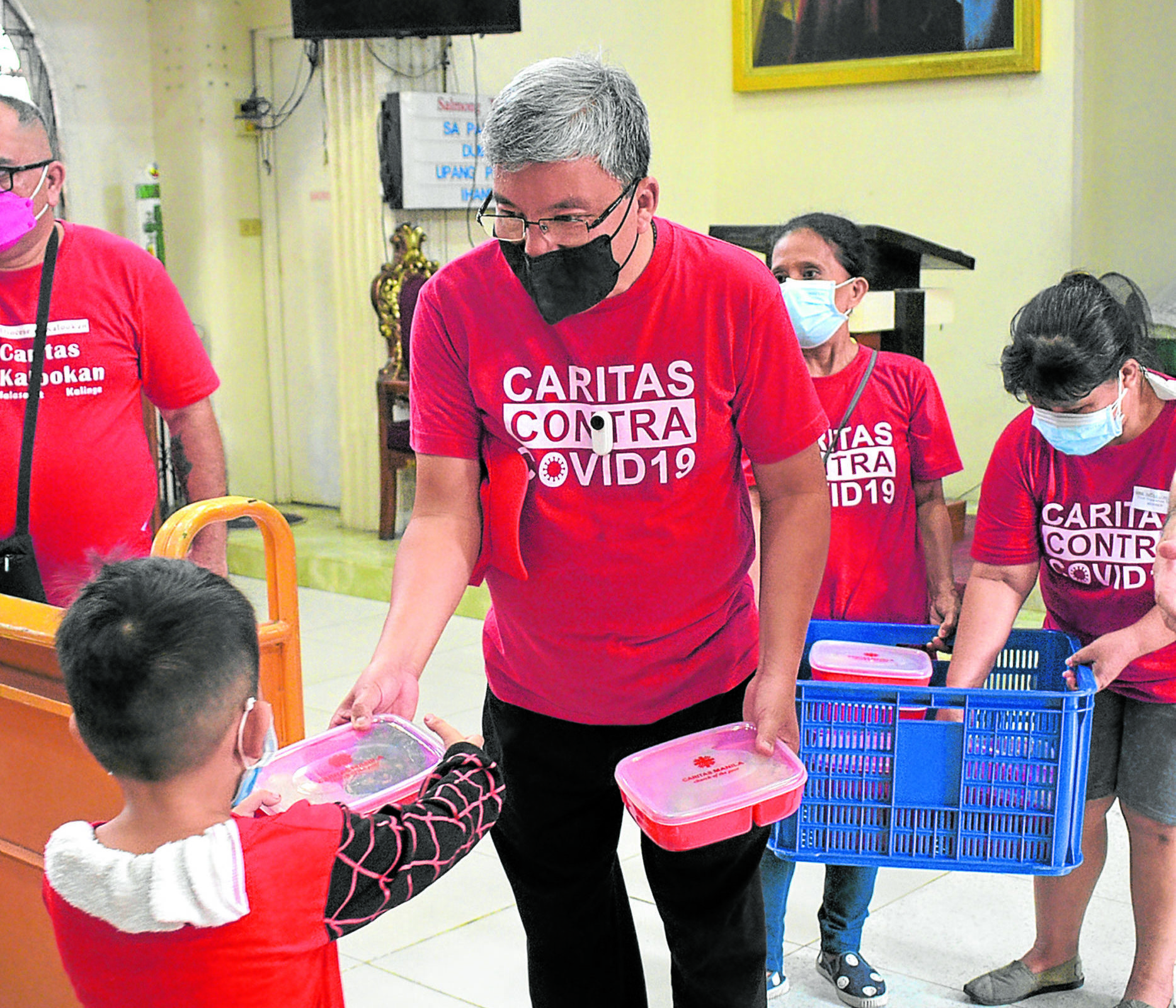 Caritas Manila executive director Fr. Anton CT Pascual leads the Hapag- Asa feeding program for malnourished children.