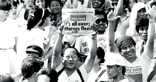 Crowds celebrate the Edsa uprising with an issue of the Inquirer.