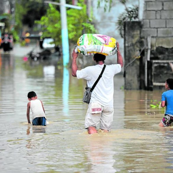 Residents wade in flood waters in San Miguel, Bulacan, a day after the onslaught of Supertyphoon “Karding” (international name: Noru). Wading in floodwaters exposes one to diseases