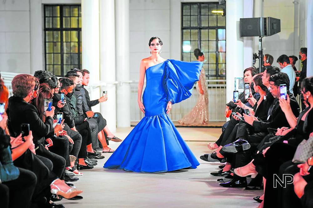 Royal blue mermaid gown with asymmetrical neckline and sculptural sleeve