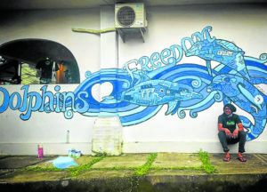 The artist with the recently completed mural no. 1,000 in Bali, Indonesia —@whaleboy2000 Instagram