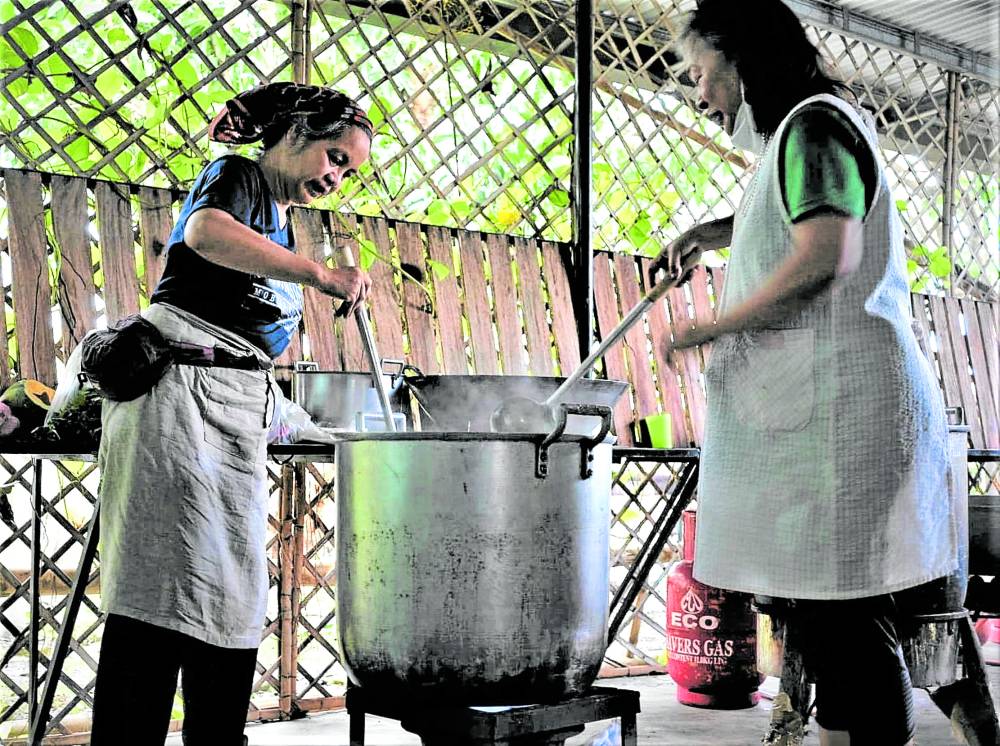 Volunteers prepare food for more than a thousand people in Barangay Castellano, San Leonardo, Nueva Ecija. 