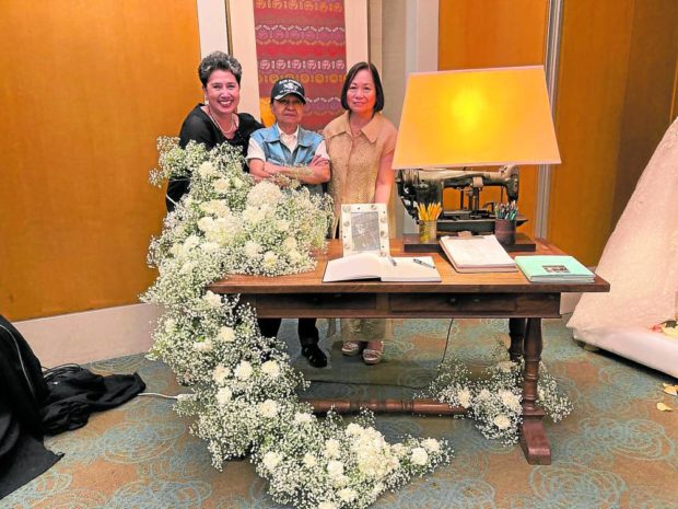 The author, Neng Cordero and Thelma San Juan behind Auggie’s desk
