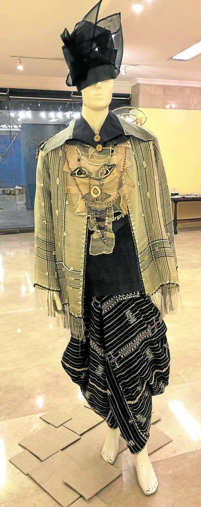 Judas’ materialism is expressed in an abaca silk barong and banana fiber top from the Tinggian, an elaborate chest plate with his face and
“kinamayan” draped trousers.