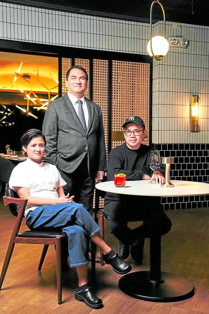 Chefs Quenee Vilar and Nicco Santos (seated) with partner Nilo Divina