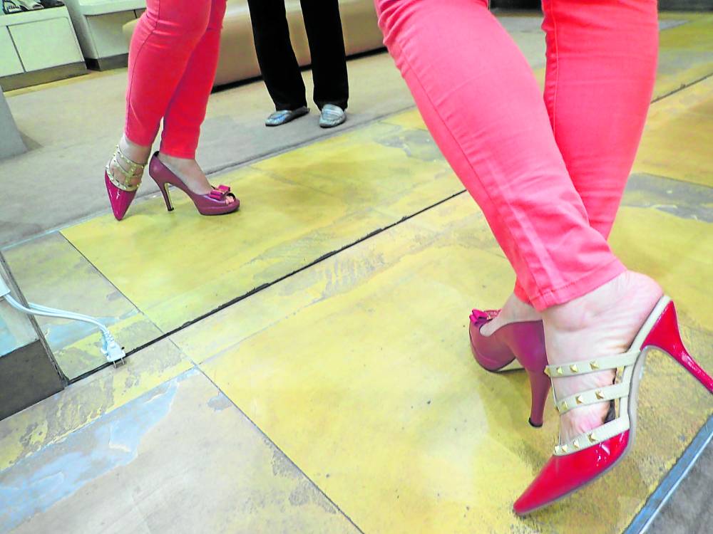 A customer tries on a pair of high heels. —NASTASHA VERAYO DE VILLA