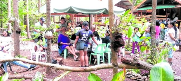 During the healing sessions, tourism officer Aldrina Braxton (seated, in blue) is given a traditional ritual massage.
