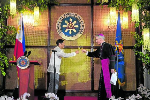 President Marcos and Archbishop Charles Brown, dean of the Diplomatic Corps, share a toast