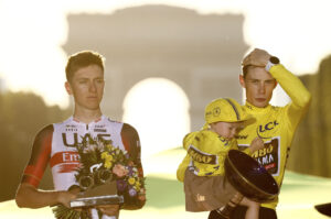 FILE PHOTO: Cycling - Tour de France - Stage 21 - Paris La Defense Arena to Champs-Elysees - France - July 24, 2022 Jumbo - Visma's Jonas Vingegaard celebrates on the podium with trophy wearing the overall leader's yellow jersey after winning the Tour de France with second placed UAE Team Emirates' Tadej Pogacar. REUTERS/Christian Hartmann/File Photo