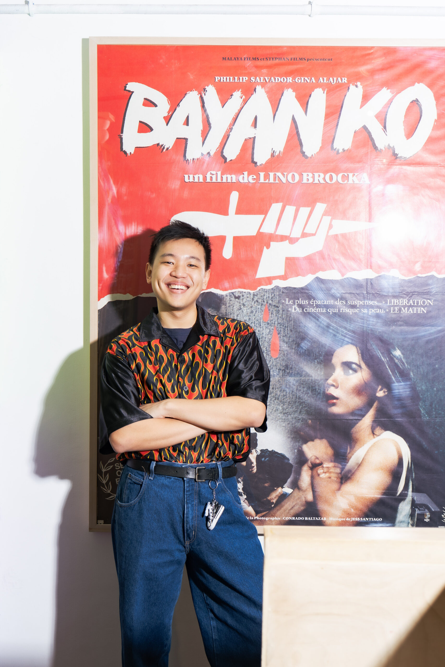 Fed Pua by the rare, meter-high poster of Lino Brocka's film "Bayan Ko" in French