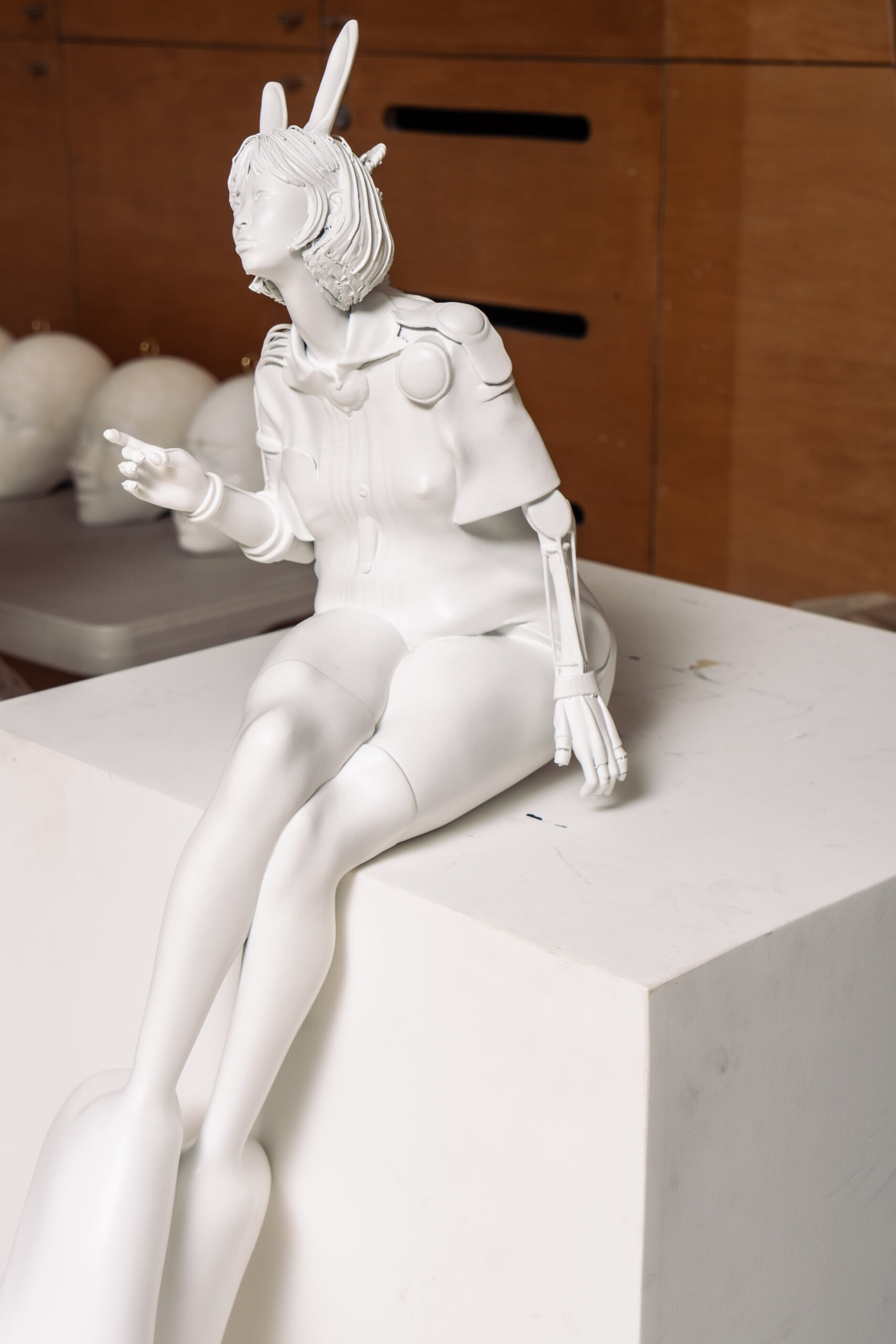 sculptures of person with rabbit eats