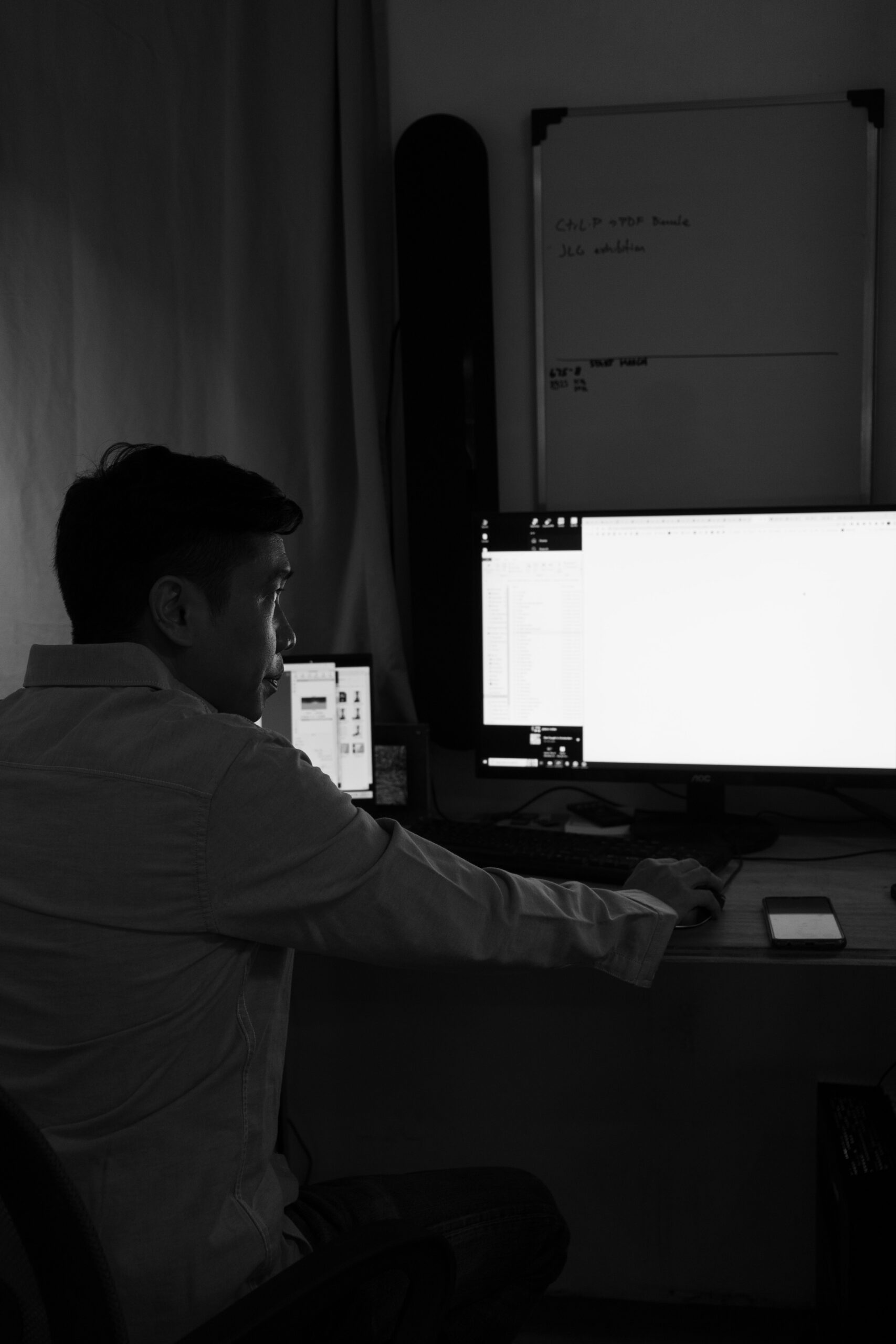 man with computer in black and white