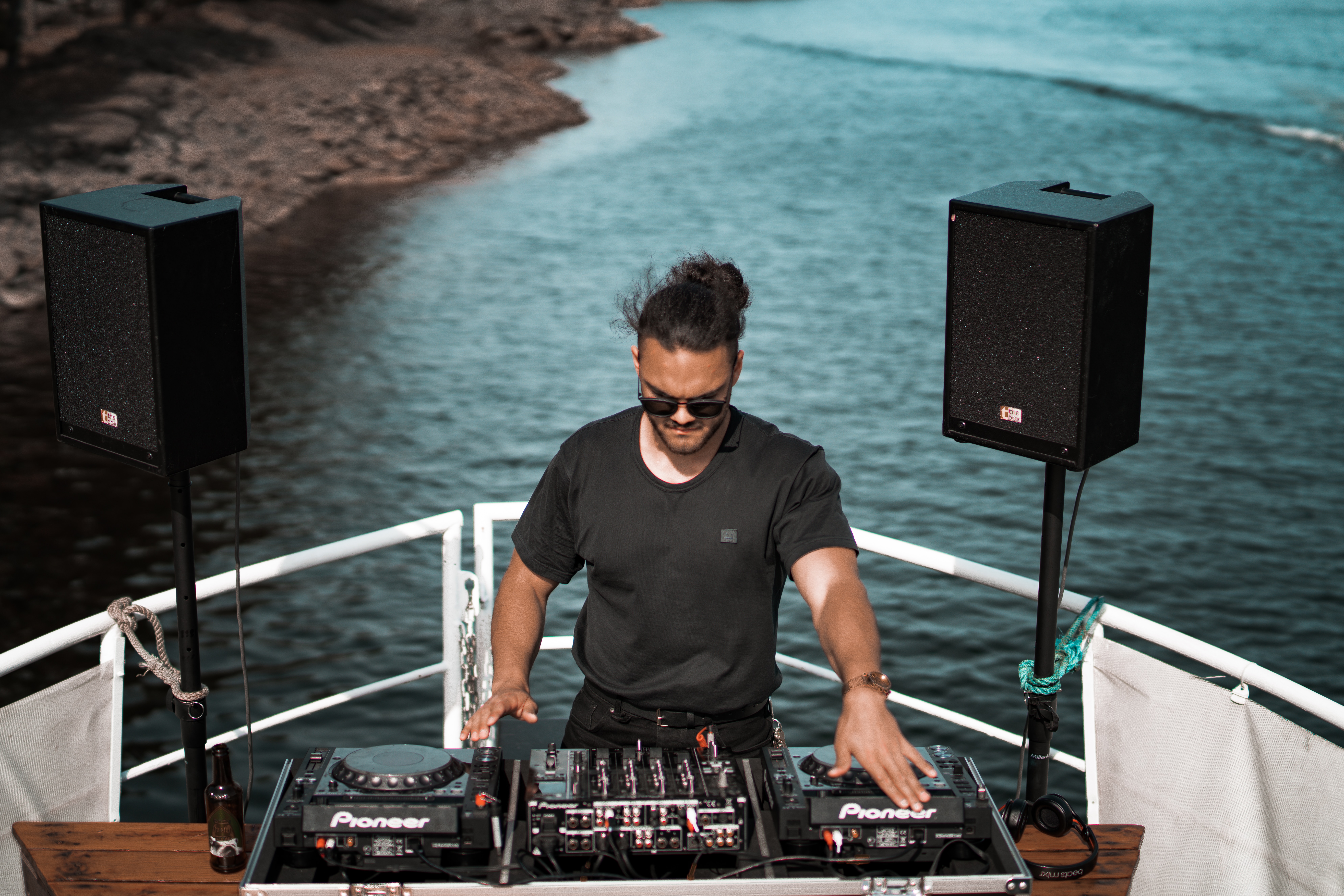 dj in a boat by the sea boat party