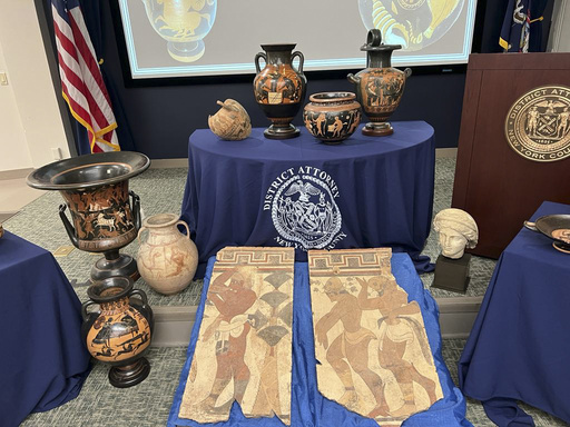 In this picture made available by the Italian Carabinieri, paramilitary police, Friday, Aug. 11, 2023, some of the 266 266 antiquities returned from the United States to Italy are displayed during a handing over ceremony t the offices of the Manhattan district attorney. Italy on Friday celebrated the return of 266 antiquities from the United States, including Etruscan vases and ancient Roman coins and mosaics worth tens of millions of euros (dollars), that were looted from Italian soil and sold to U.S. museums and private collectors. (Italian Carabinieri Via AP)