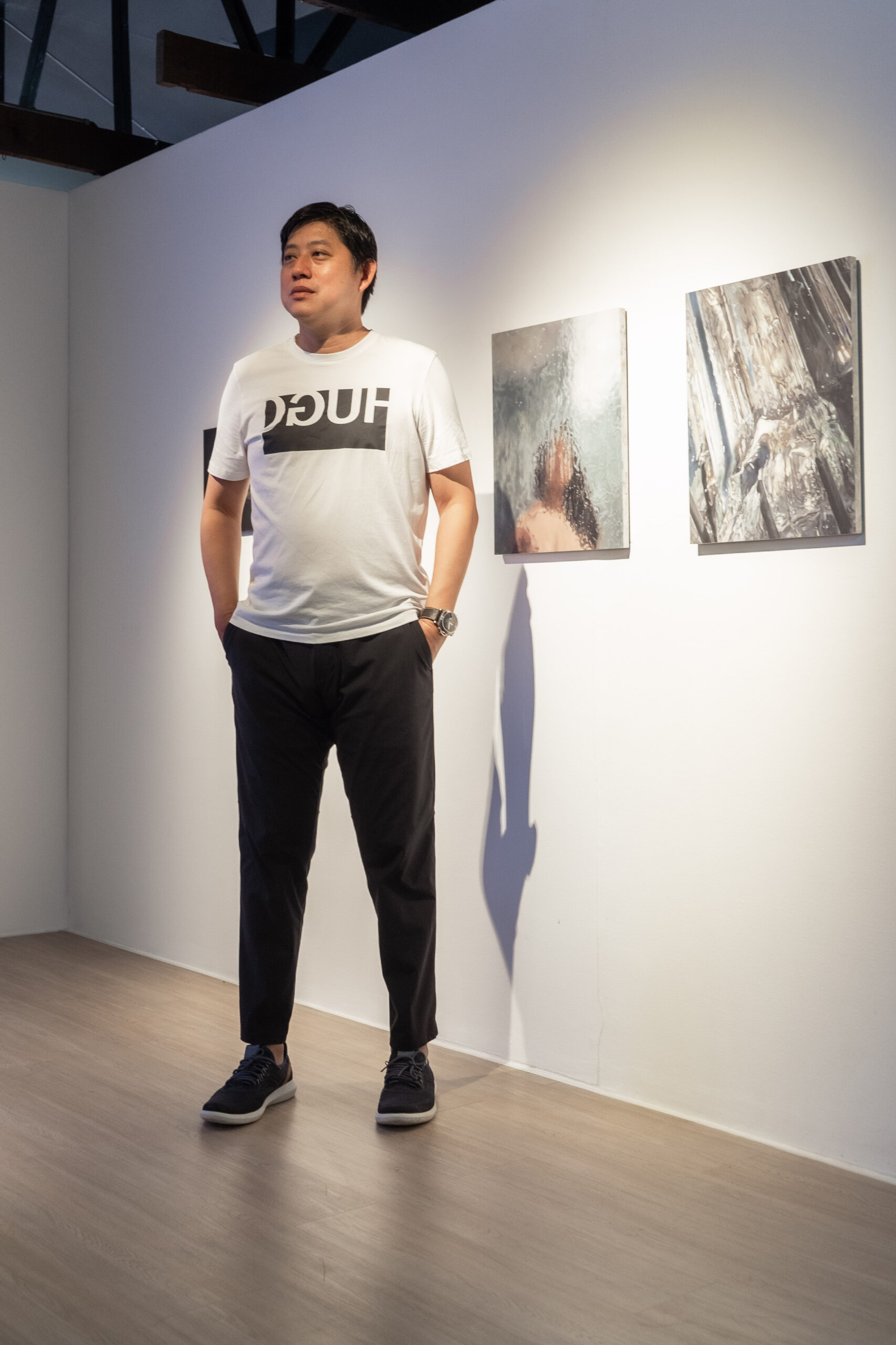 tall man in front of artwork