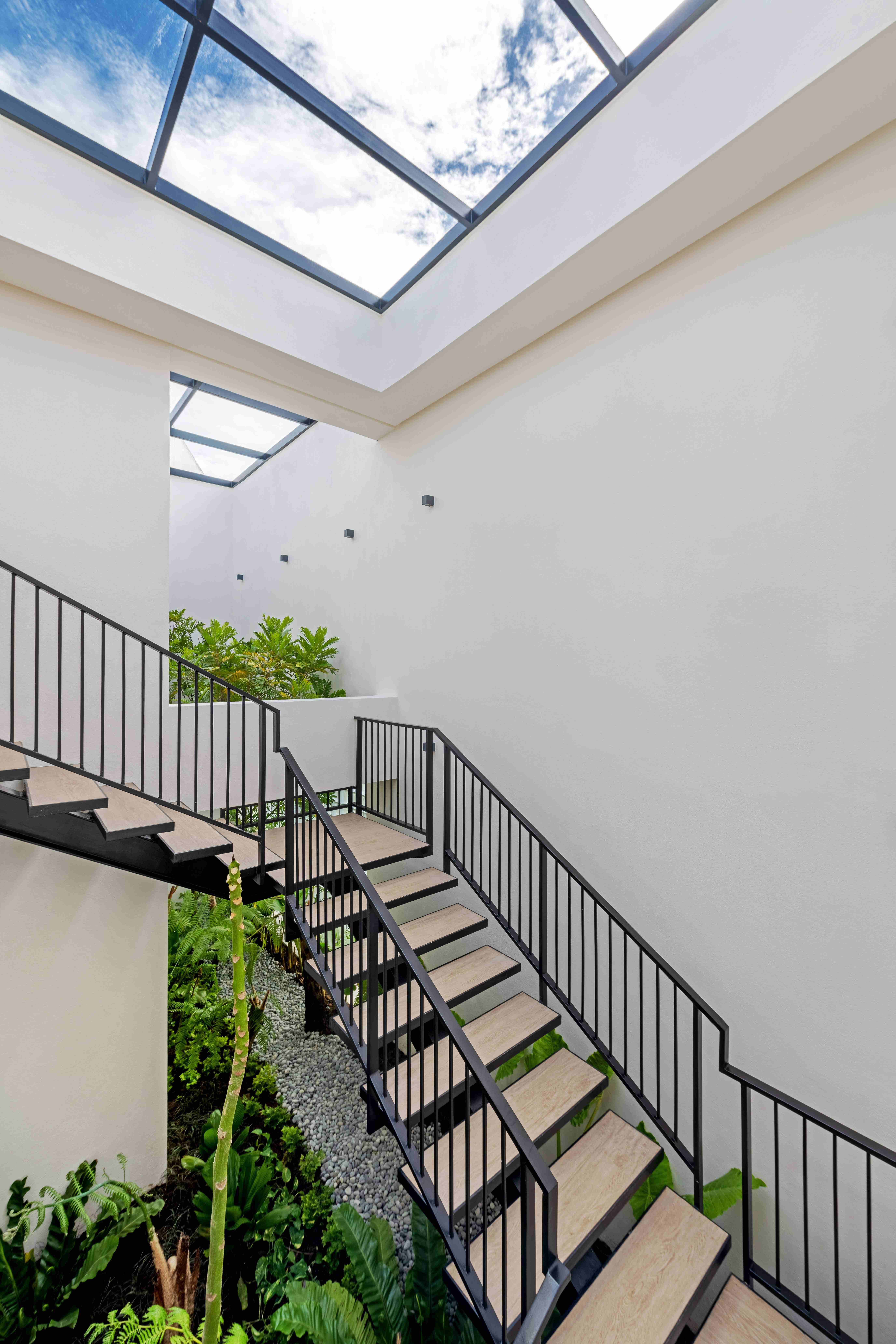 vie interior with stairs, greenery, and natural light