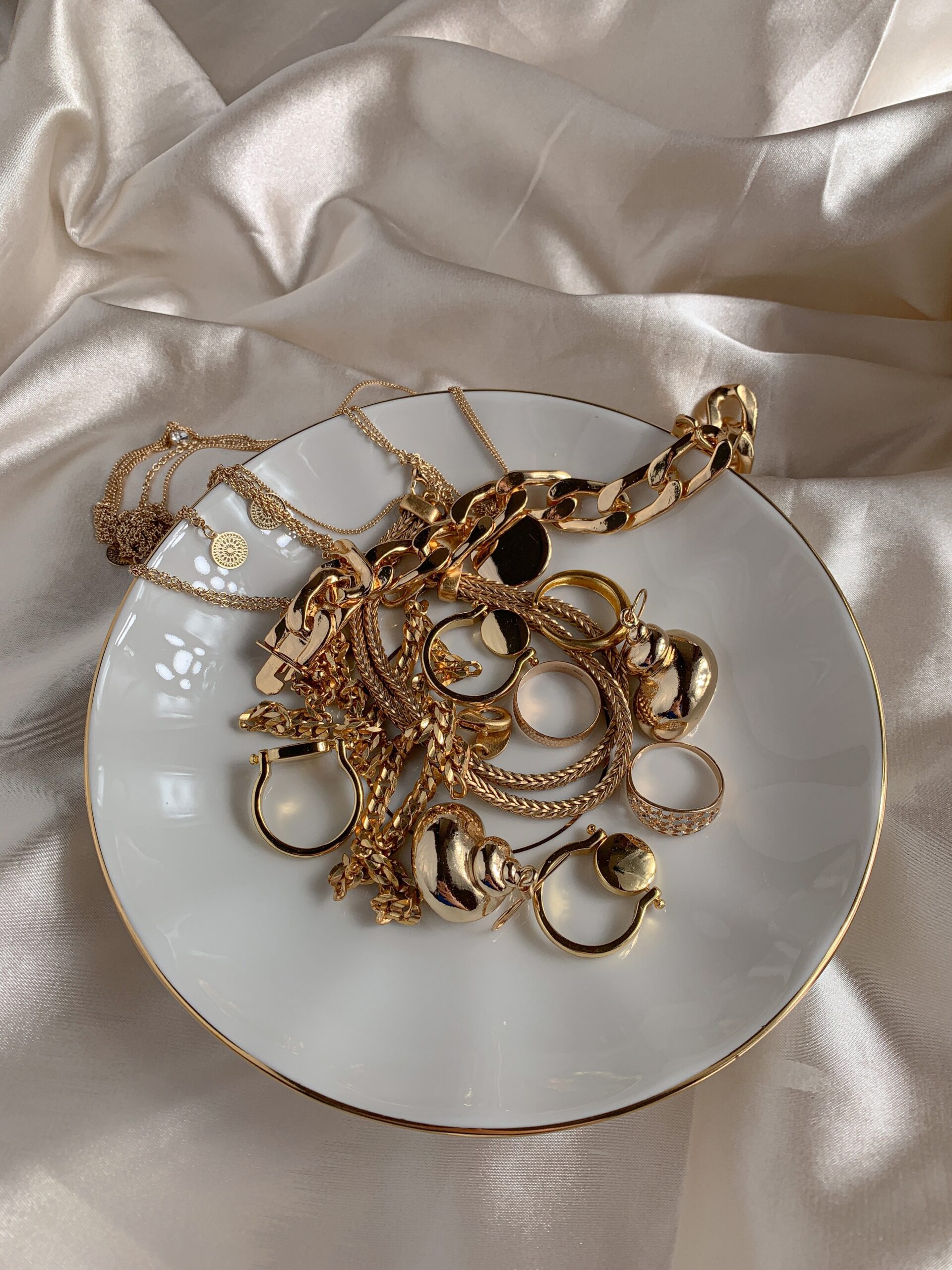gold jewelry on a catch plate