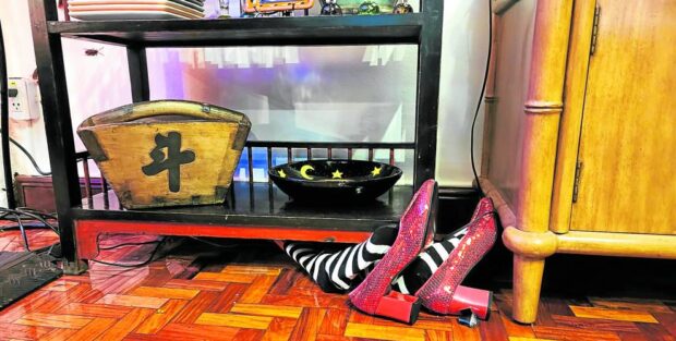 Witches’ feet and shoes protruding from under the cabinets—very “Wizard of Oz” —RUTH L. NAVARRA