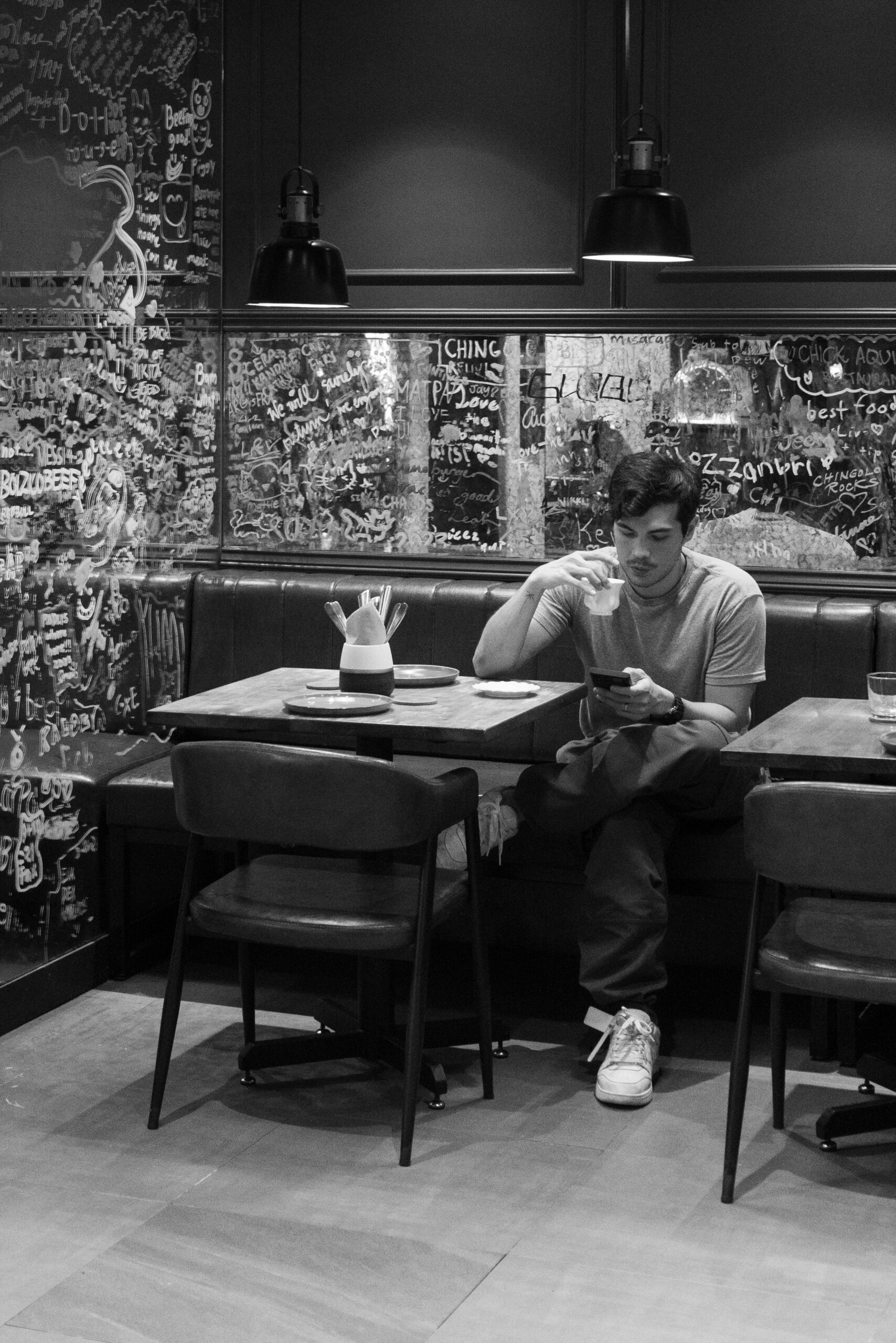 man in restaurant black and white