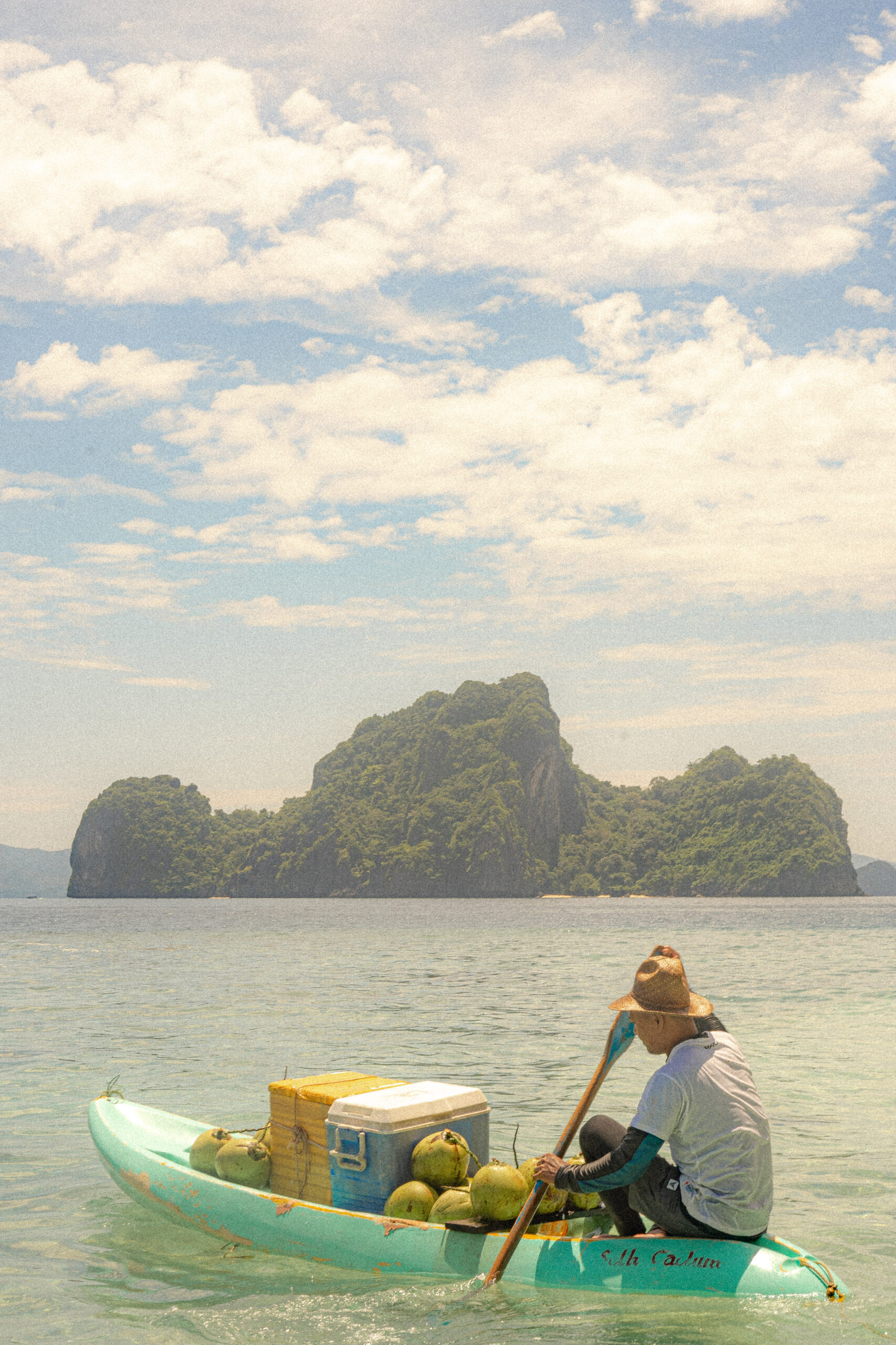 A boat-riding vendor selling coconuts and other beverages | Photo courtesy of JT Fernandez
