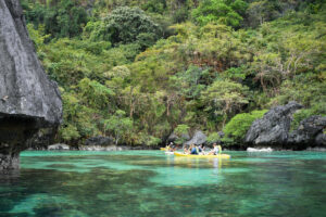 This photo taken on December 12, 2023 shows tourists paddling their kayaks inside the Big Lagoon in El Nido town, Palawan province.