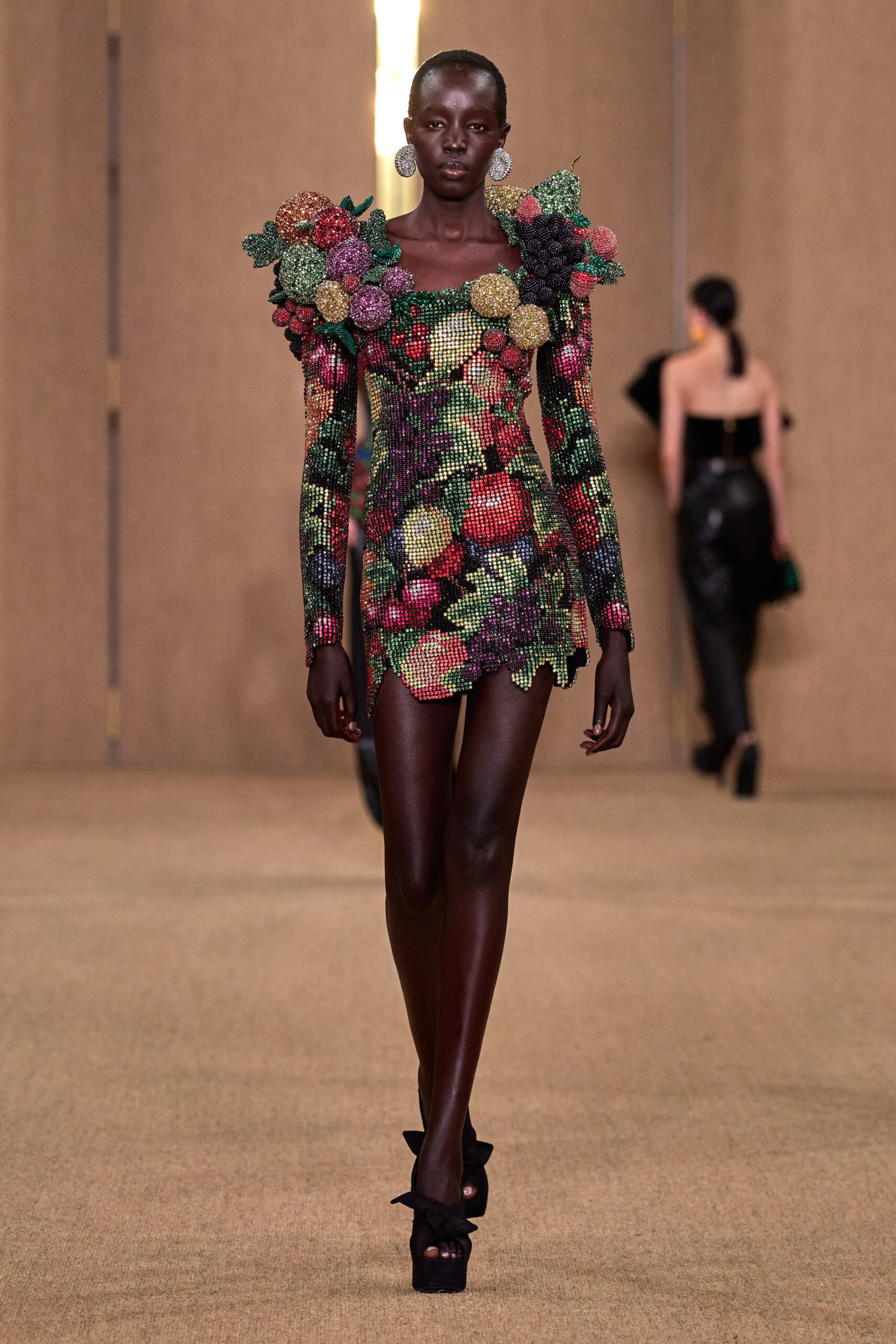Model on runway in floral inspired dress