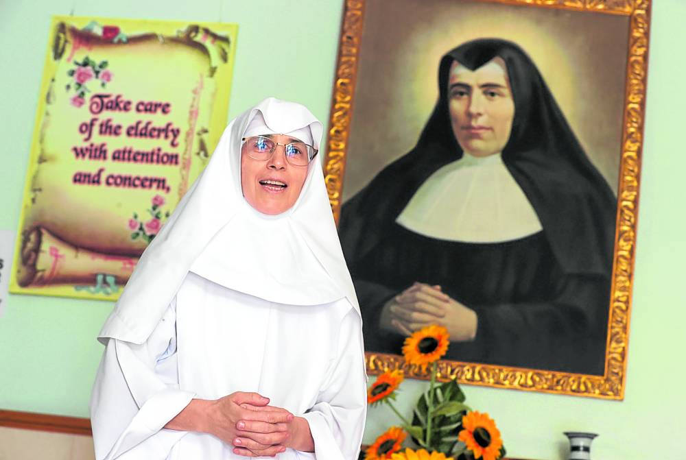 Sister Sandra da Silva, with a portrait of the Little Sisters foundress St. Teresa of Jesus Jornet Ibars —PHOTOS BY NIÑO JESUS ORBETA