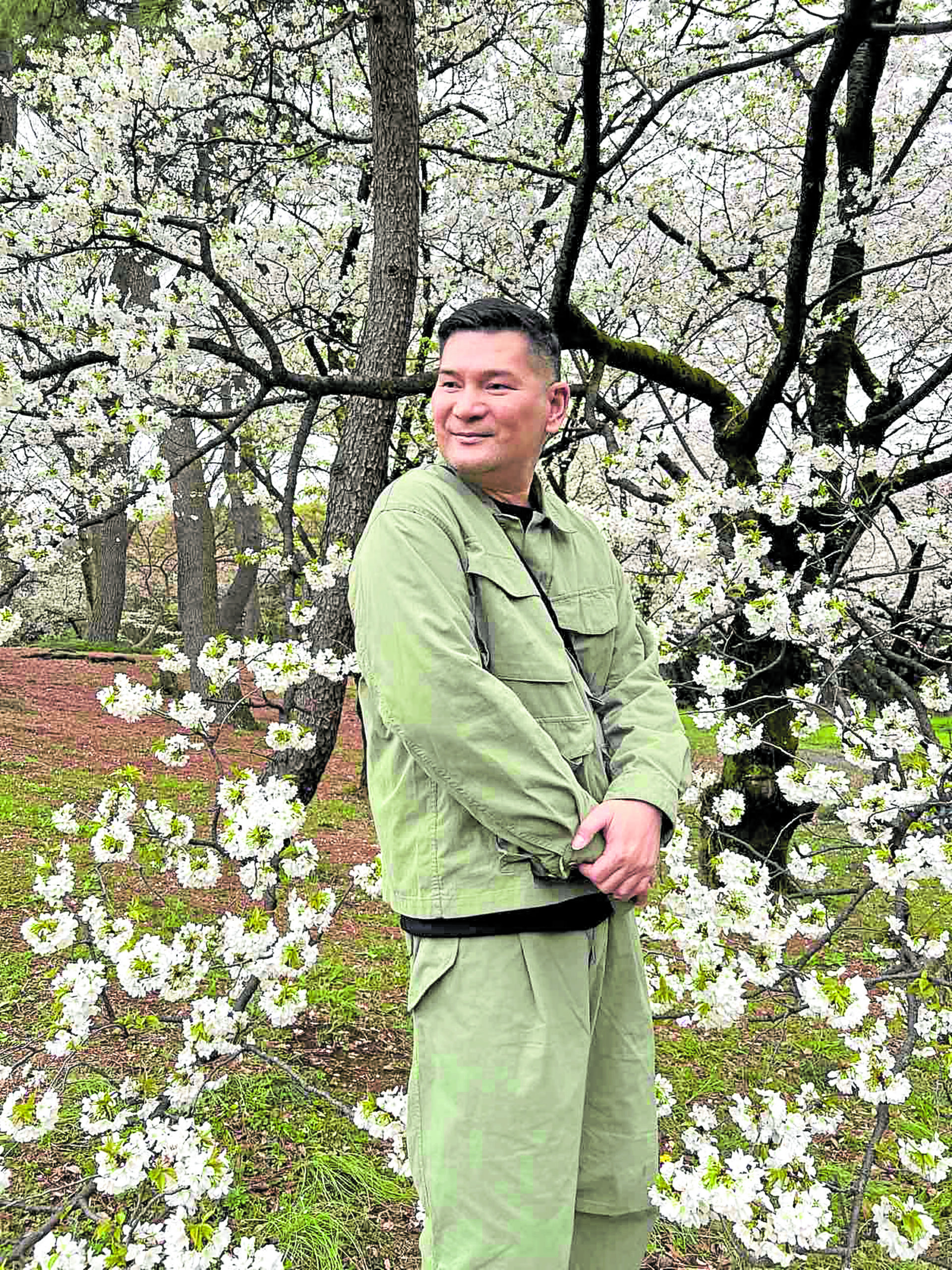 Robby Carmona amid cherry blossoms in Tokyo