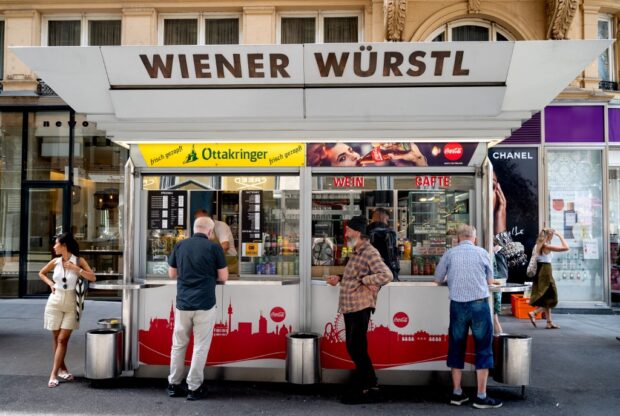 Customers queue outside the 'Wiener Wuerstl' sausage stand at Graben Street in Vienna, Austria on June 18, 2024. 