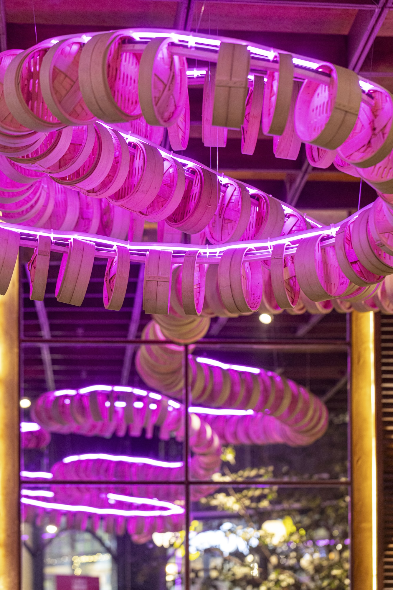 Leeroy New’s ceiling installation used bamboo dimsum baskets to create a dragon’s tail weaving in and out of the space