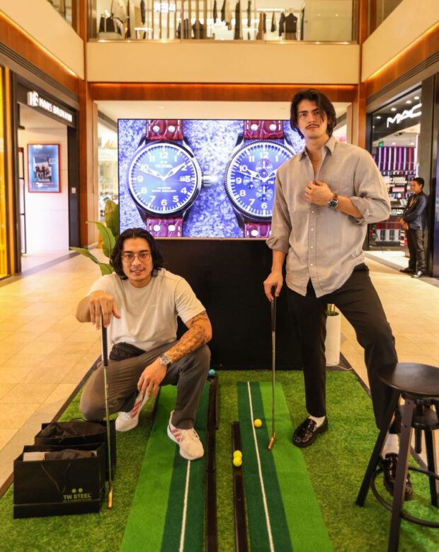 [L-R] Eric Soriano and Johannes Rissler tee off while wearing their TW Steel watches at the pop-up store in Rockwell Power Plant Mall.
