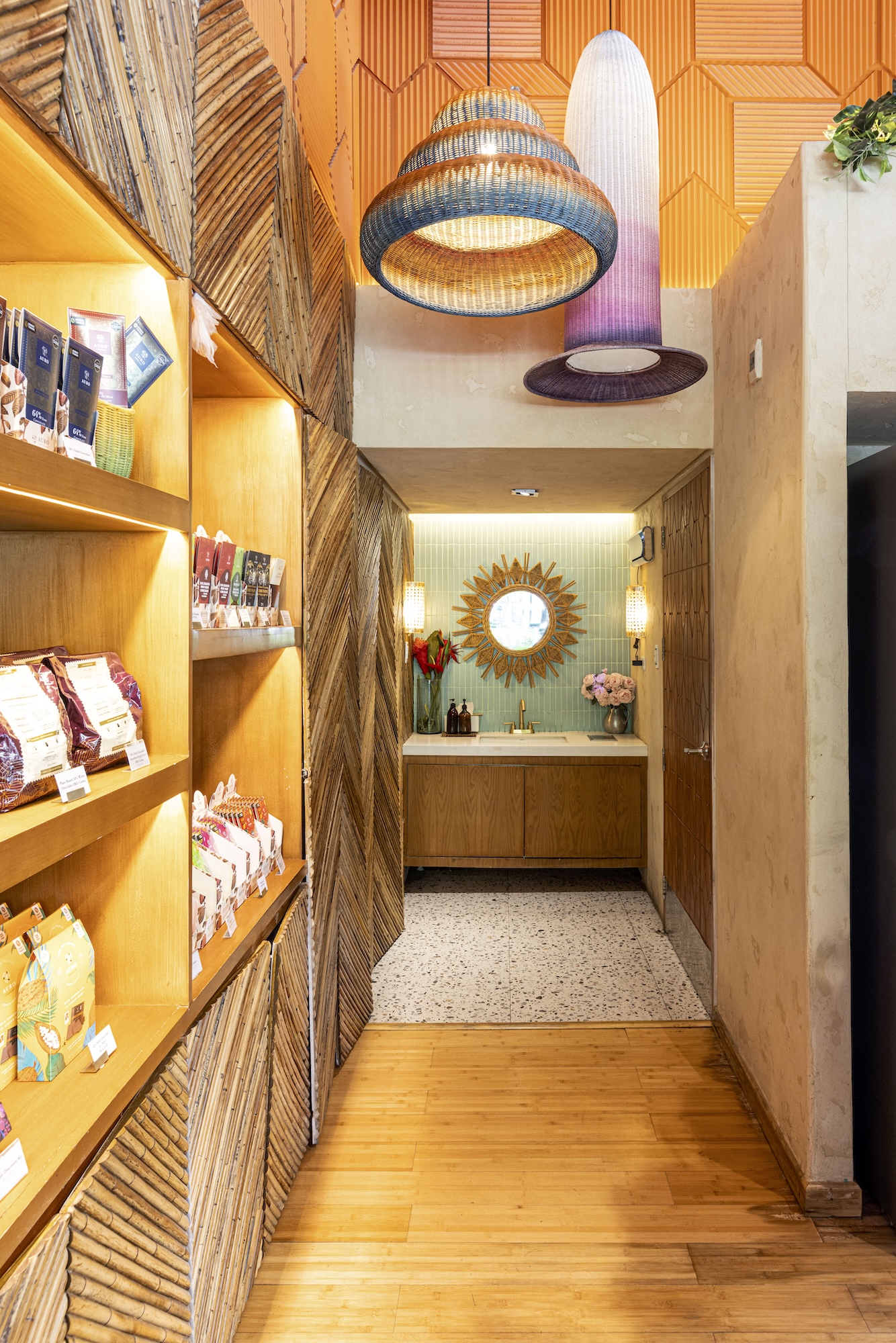 A colorful showcase leading into the Auro Chocolate Cafe jungle powder room